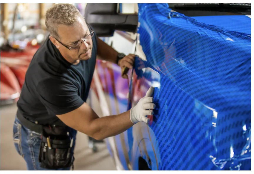 Installer applying blue vinyl